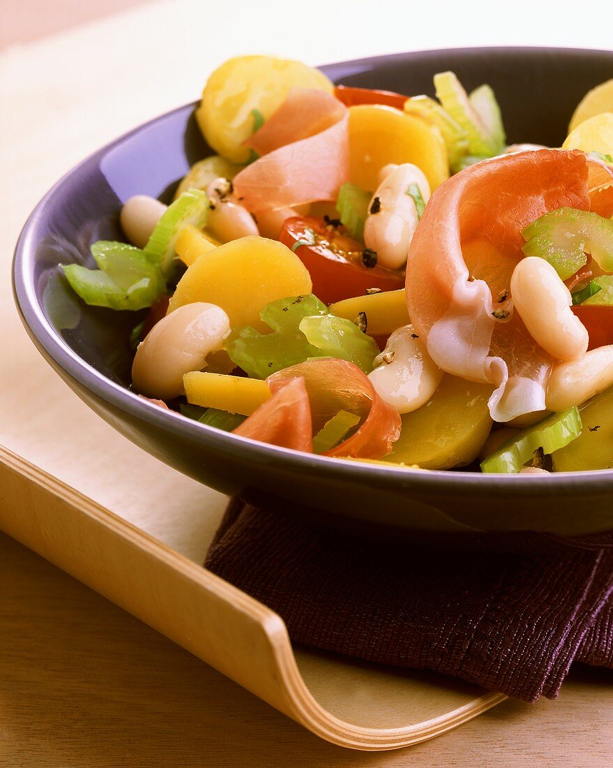 Potato and celery salad with beans and Tyrolean bacon