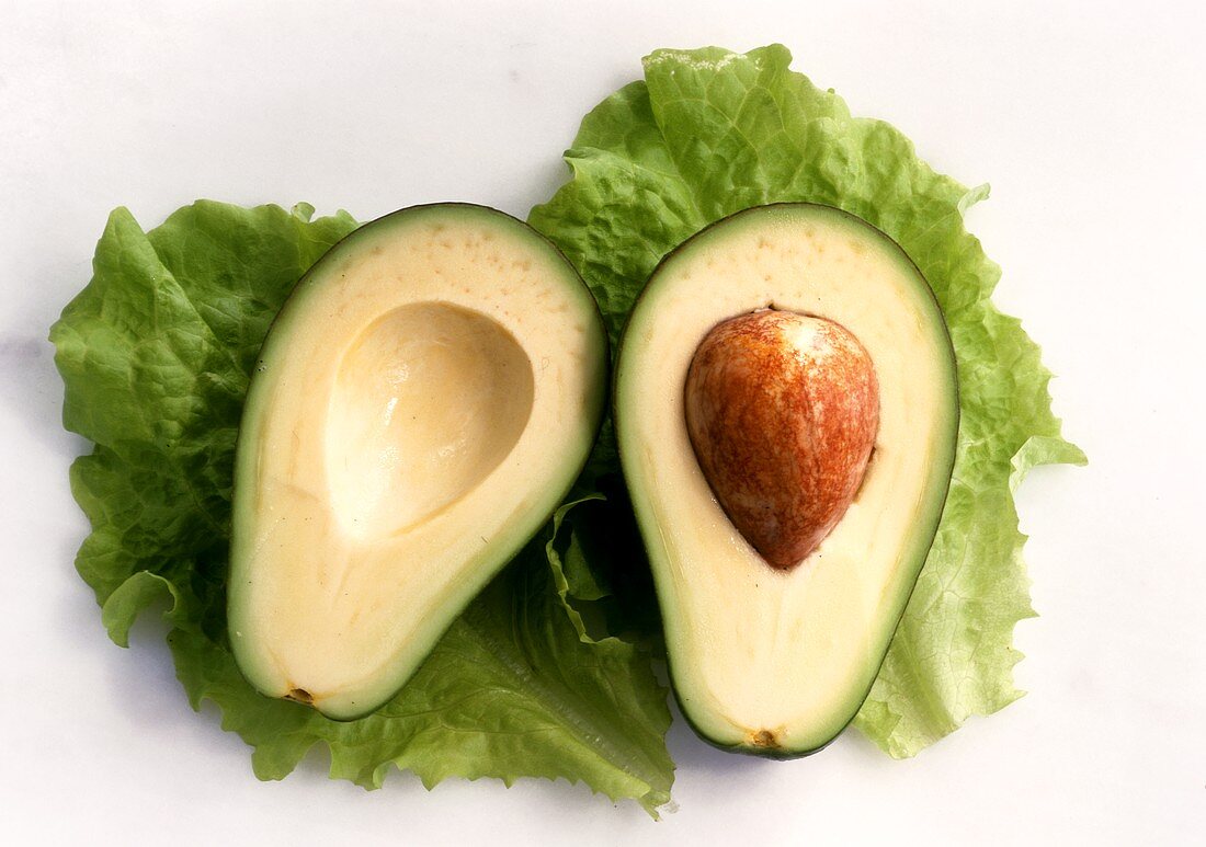 Zwei Avocadohälften auf Salatblättern