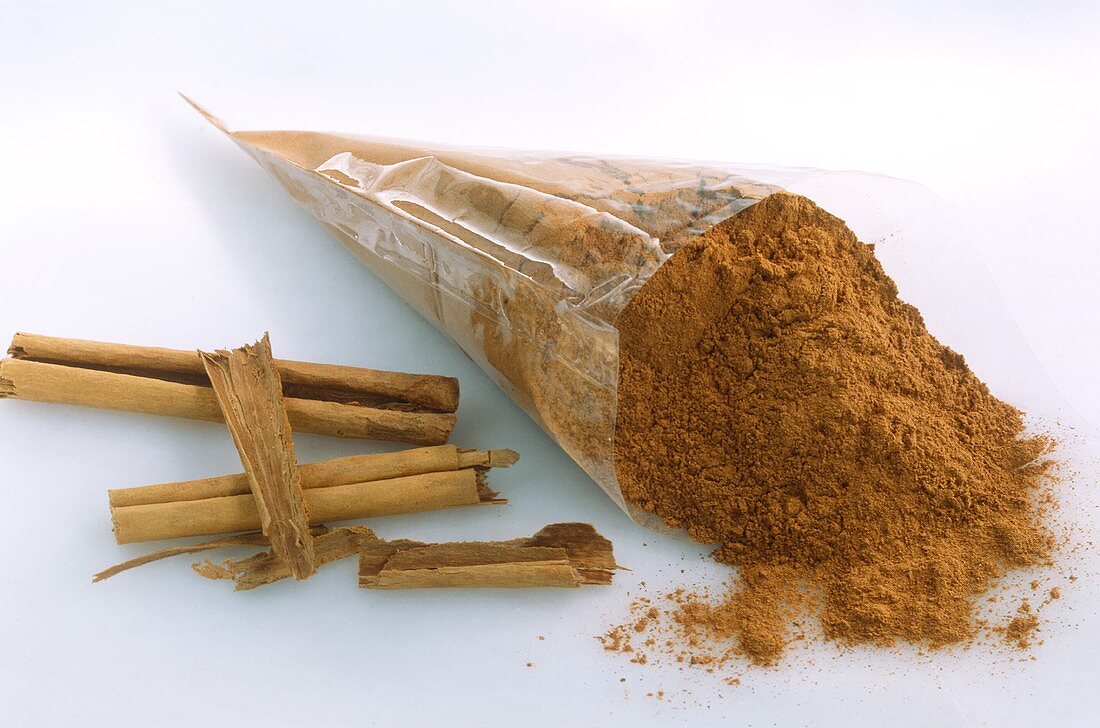Ground cinnamon in cellophane bag and cinnamon sticks