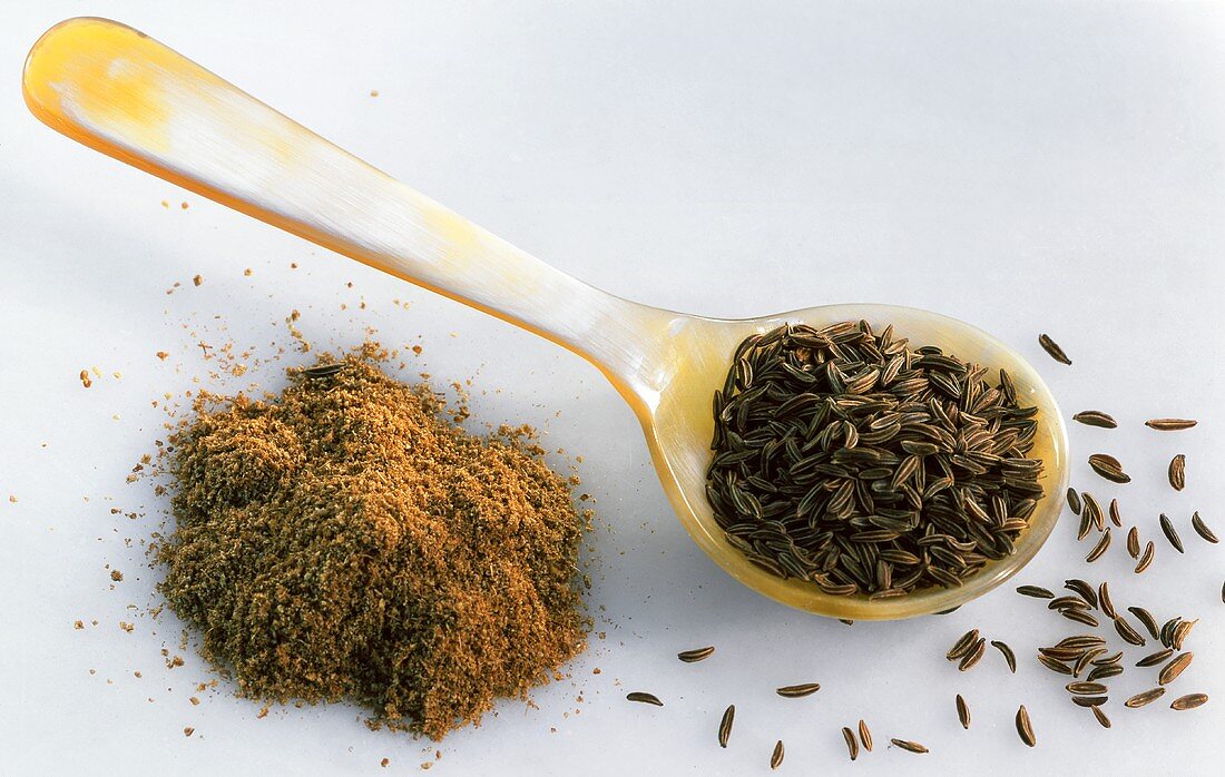 Caraway seed on spoon and ground caraway
