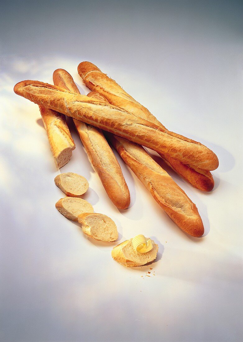 Baguette and slices of baguette with butter