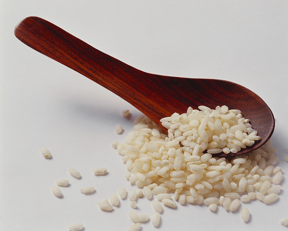 Arborio rice on wooden spoon