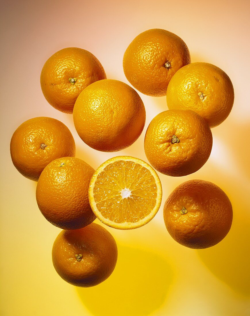 Oranges, one halved