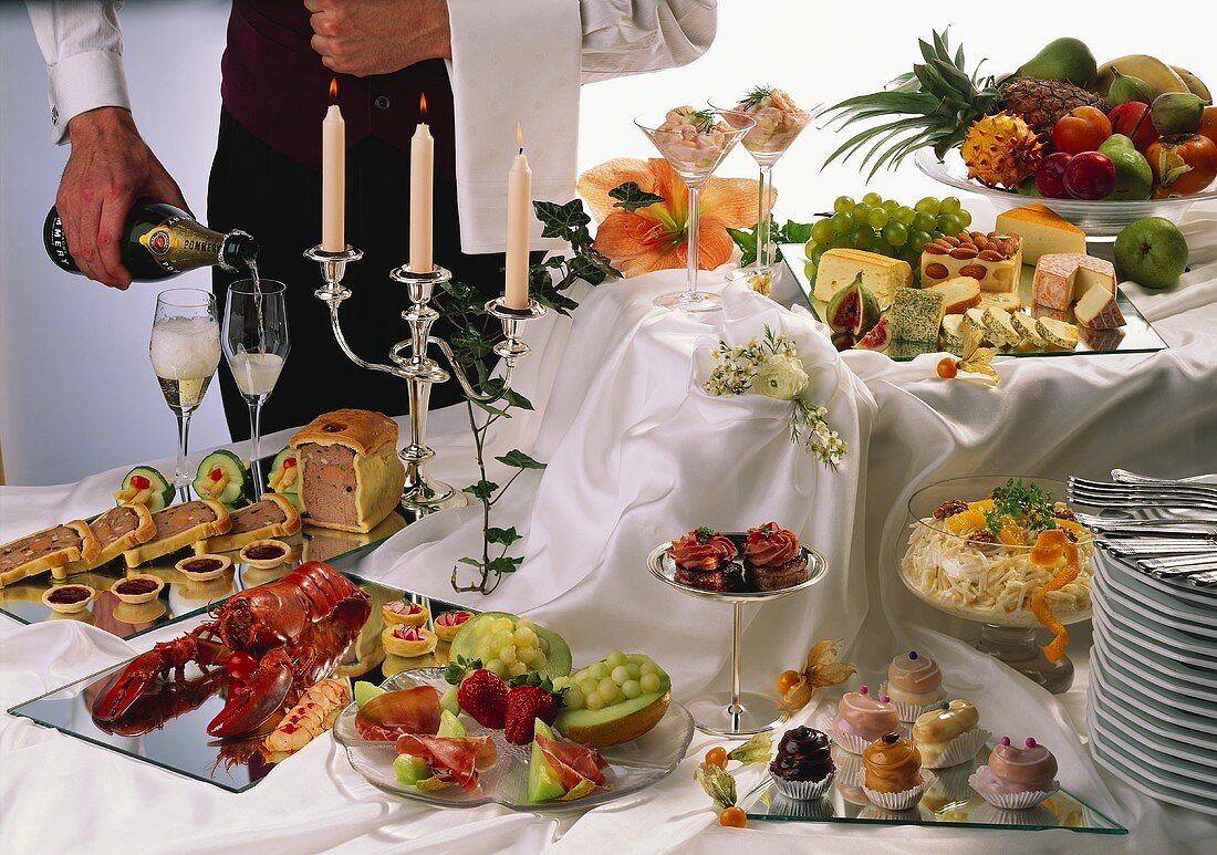 Sumptuous party buffet with champagne and waiter