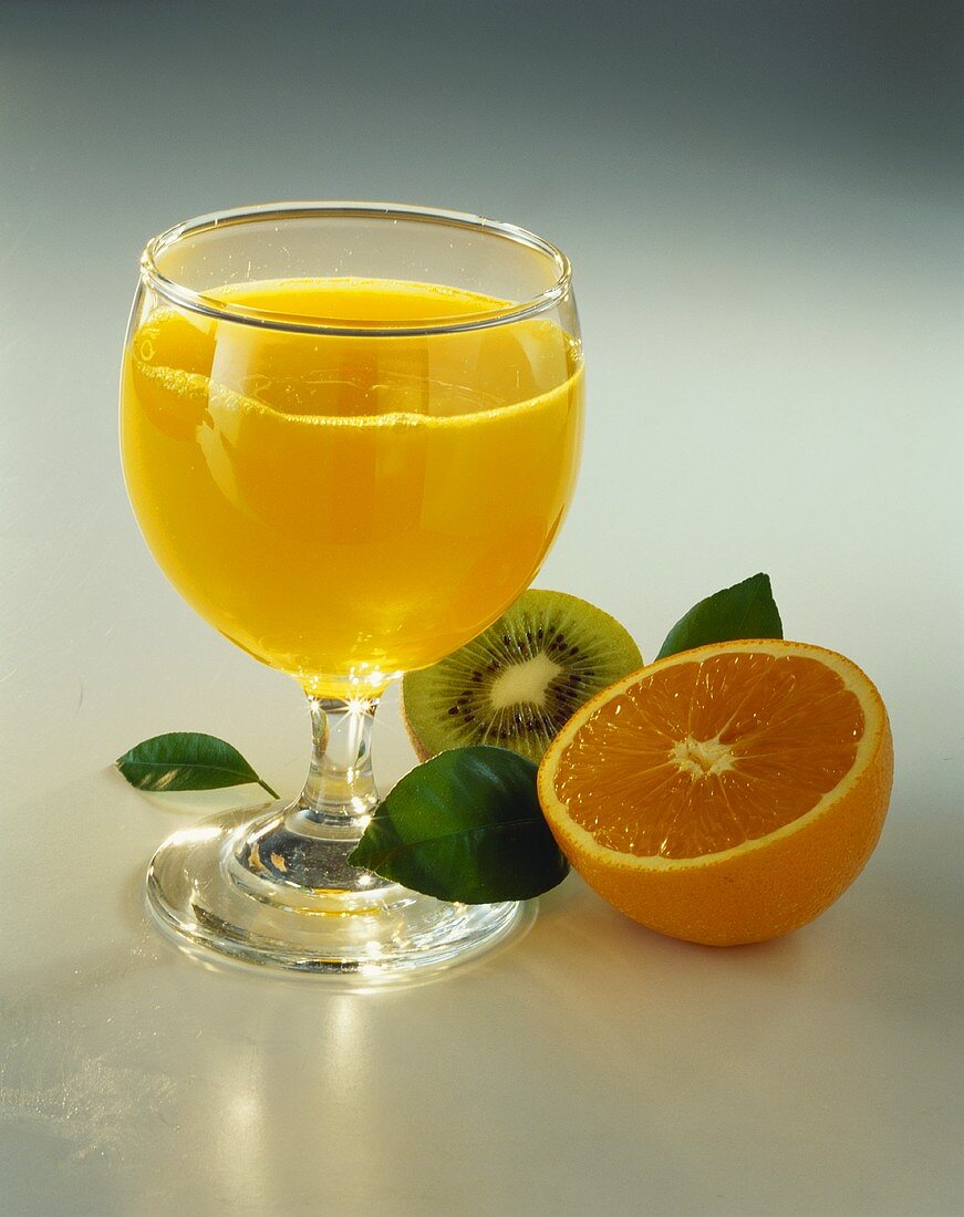 Glass of orange juice and fresh fruit