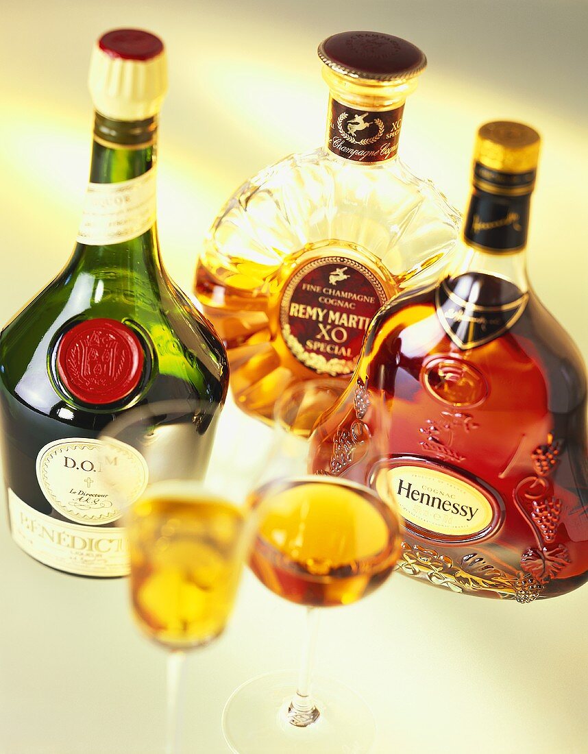 Various cognac bottles and glasses