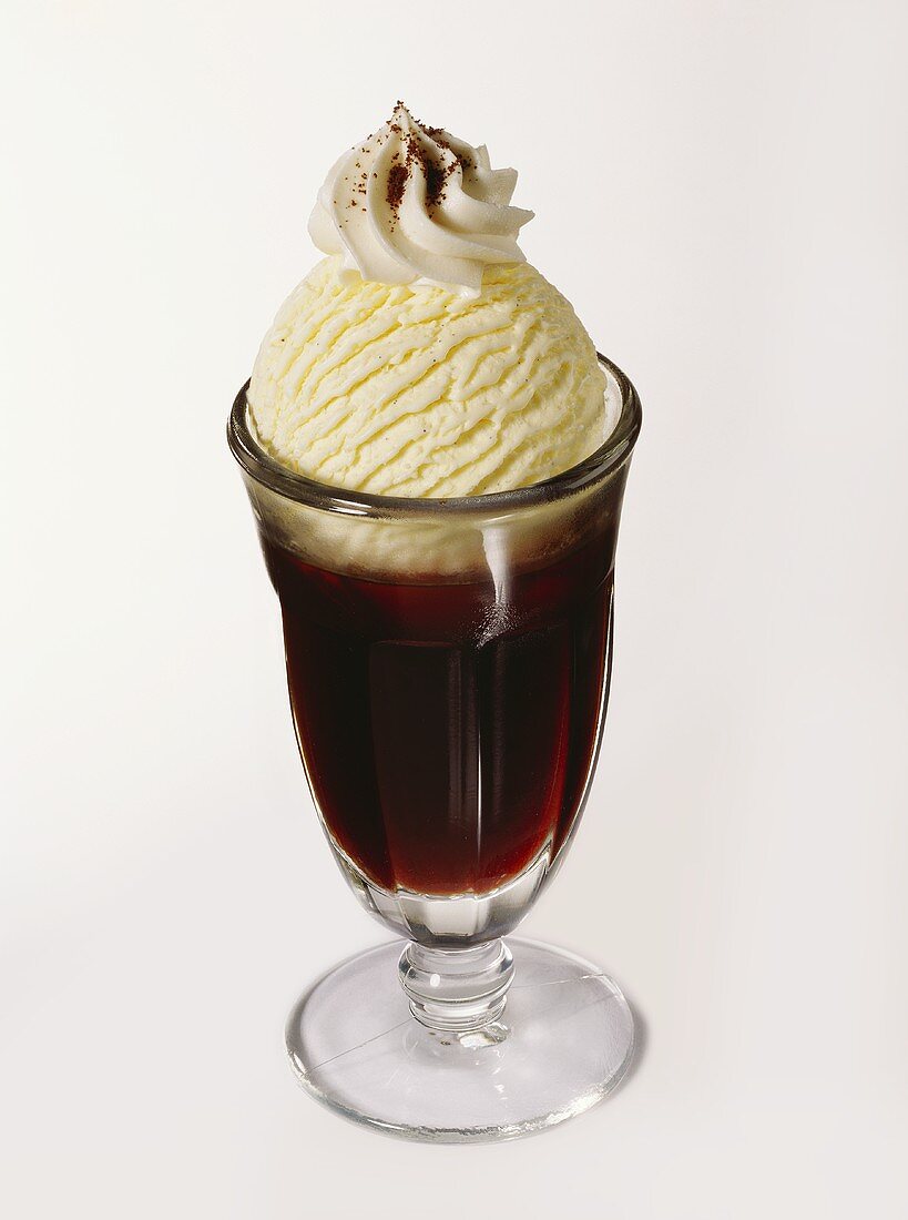 Iced coffee with vanilla ice cream and blob of cream