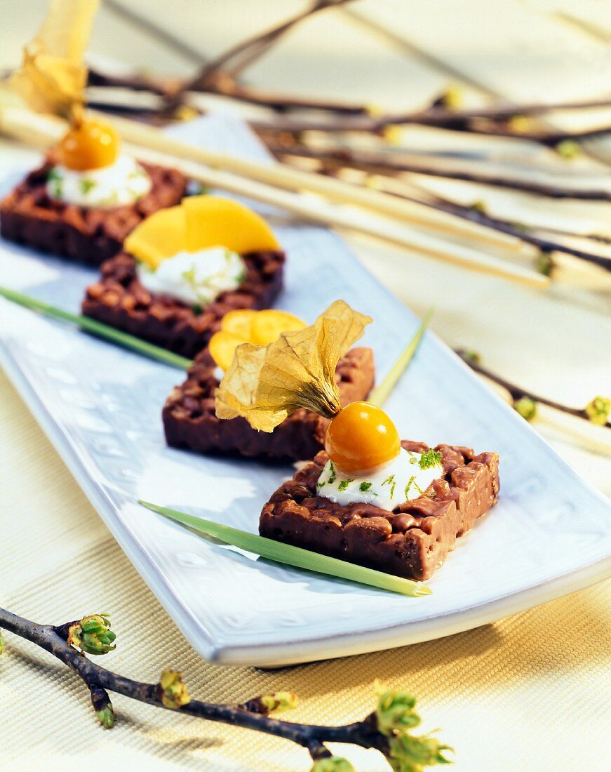 Chocolate puffed rice slices with lime sauce and fruit 