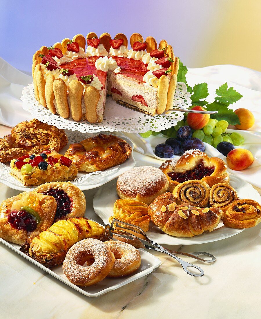 Buffet with small cakes and strawberry gateau
