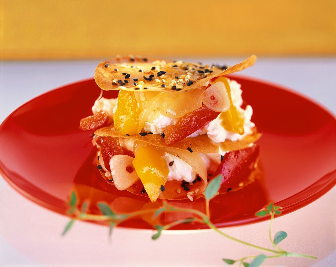 Fresh goat's cheese with crispy sesame leaves and peppers