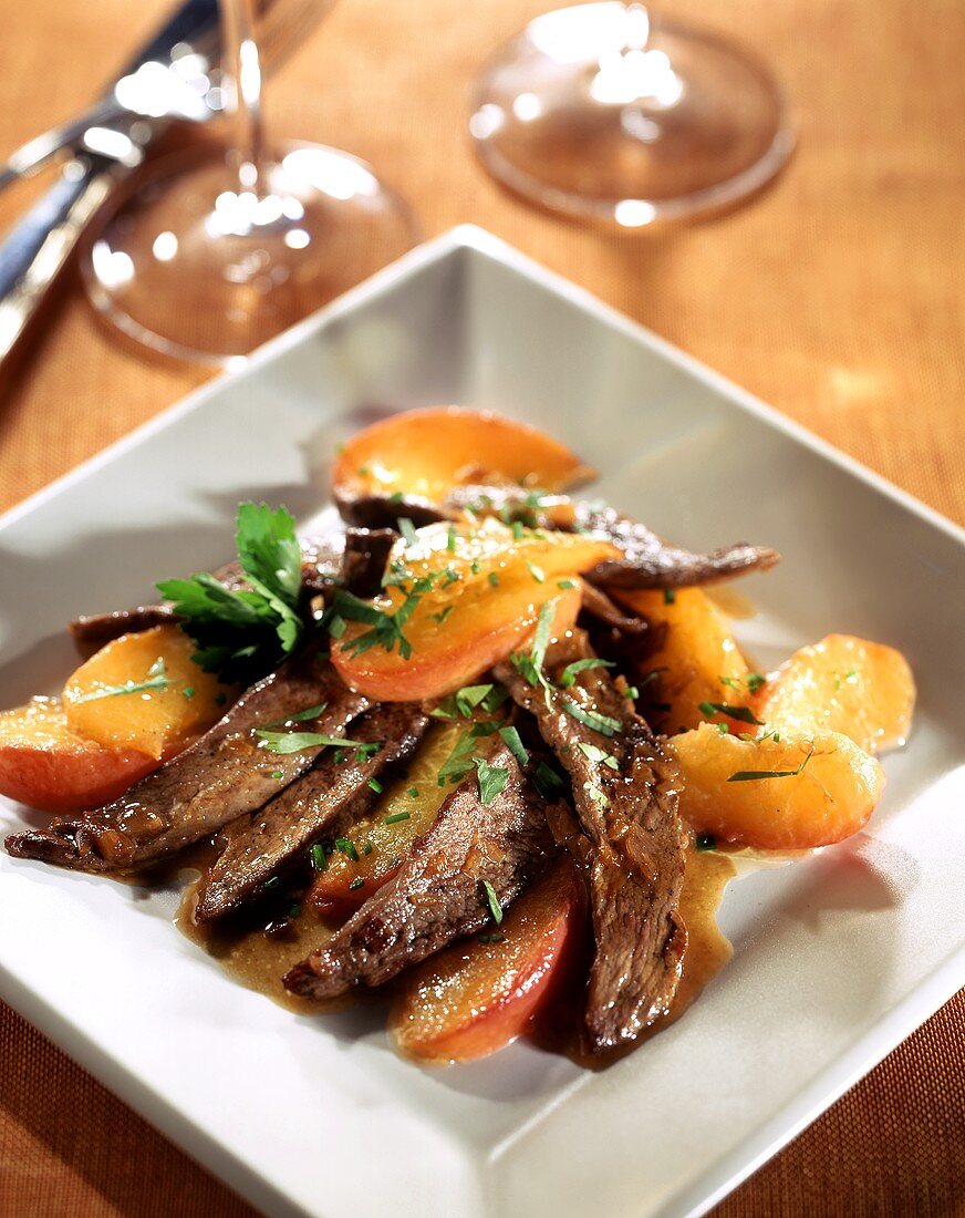 Strips of duck breast with peaches