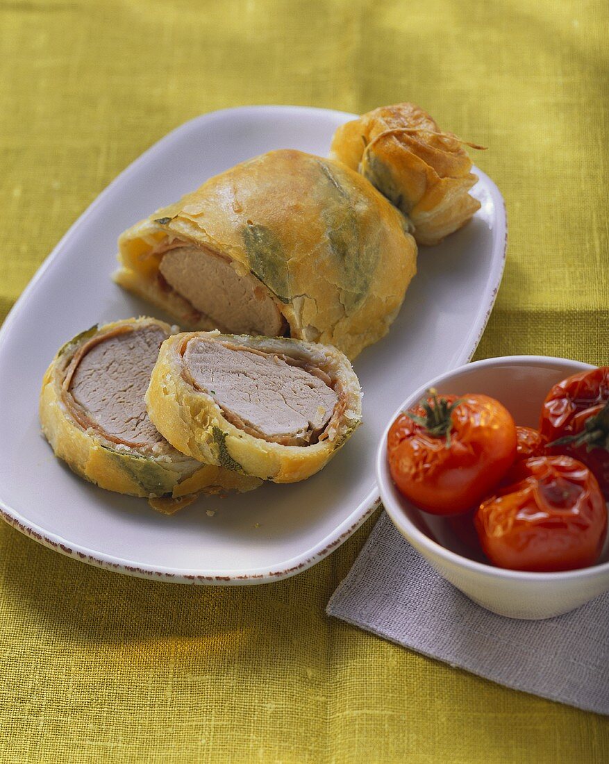 Pork fillet in sage puff pastry and braised tomatoes