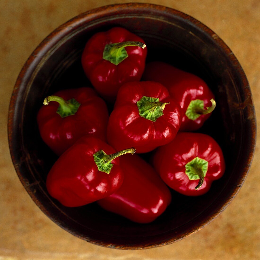 Red peppers in wooden bowl