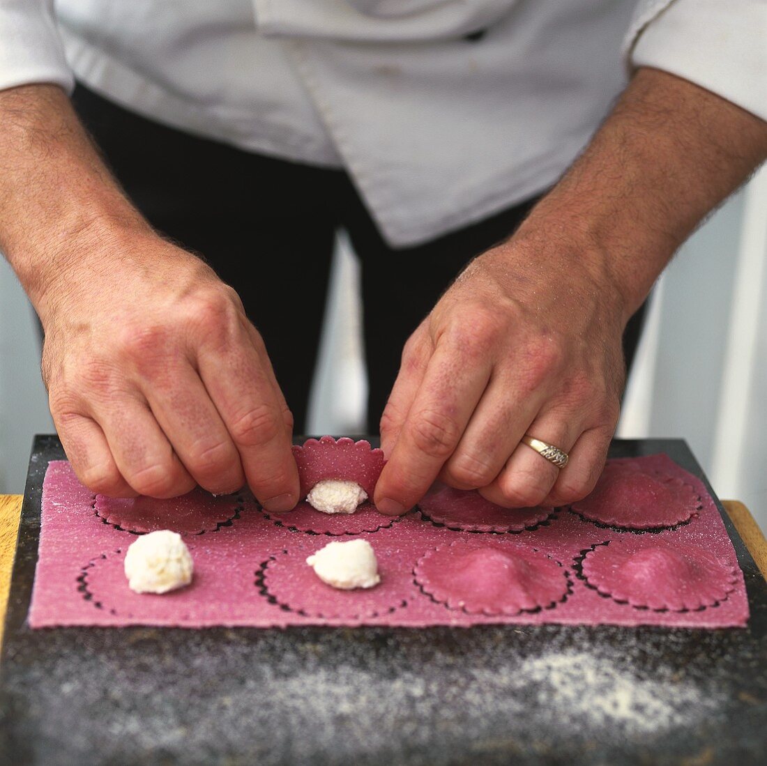 Chef filling beetroot ravioli
