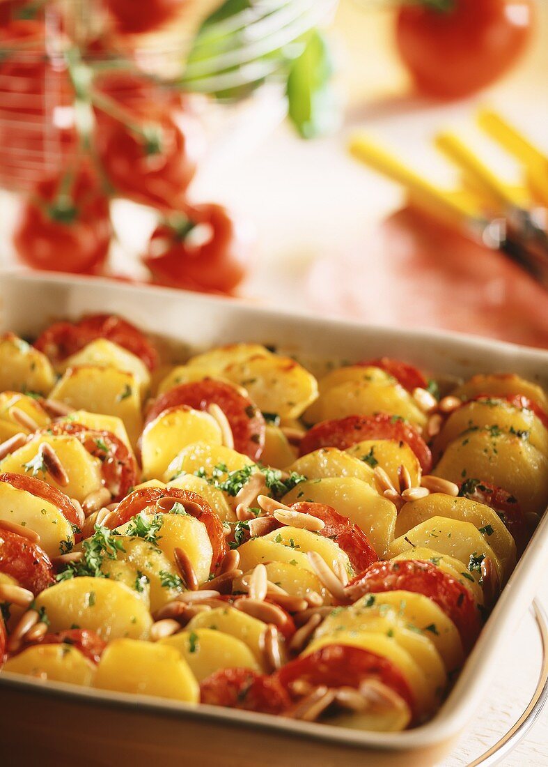 Potato and tomato gratin with pine nuts