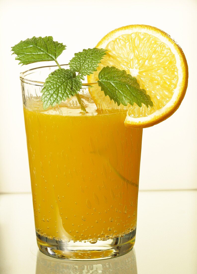 Glass of orange juice with mint