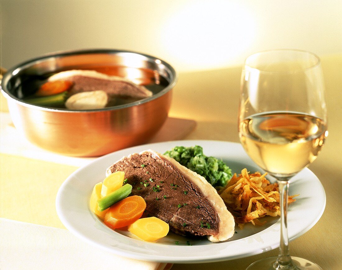 Boiled beef fillet with vegetables & rosti; white wine glass
