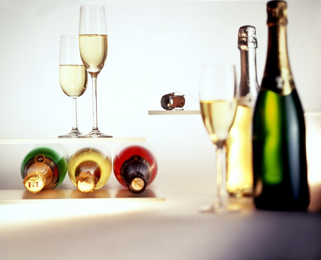 Various champagne bottles, champagne glasses and corks