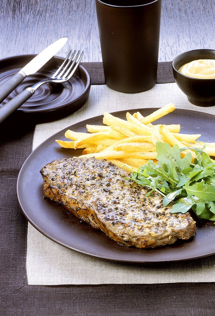 Peppered steak with chips, rocket and mustard