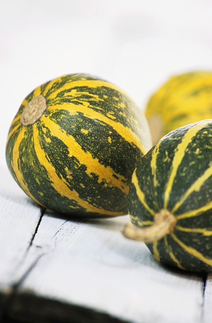 Three green and yellow squashes