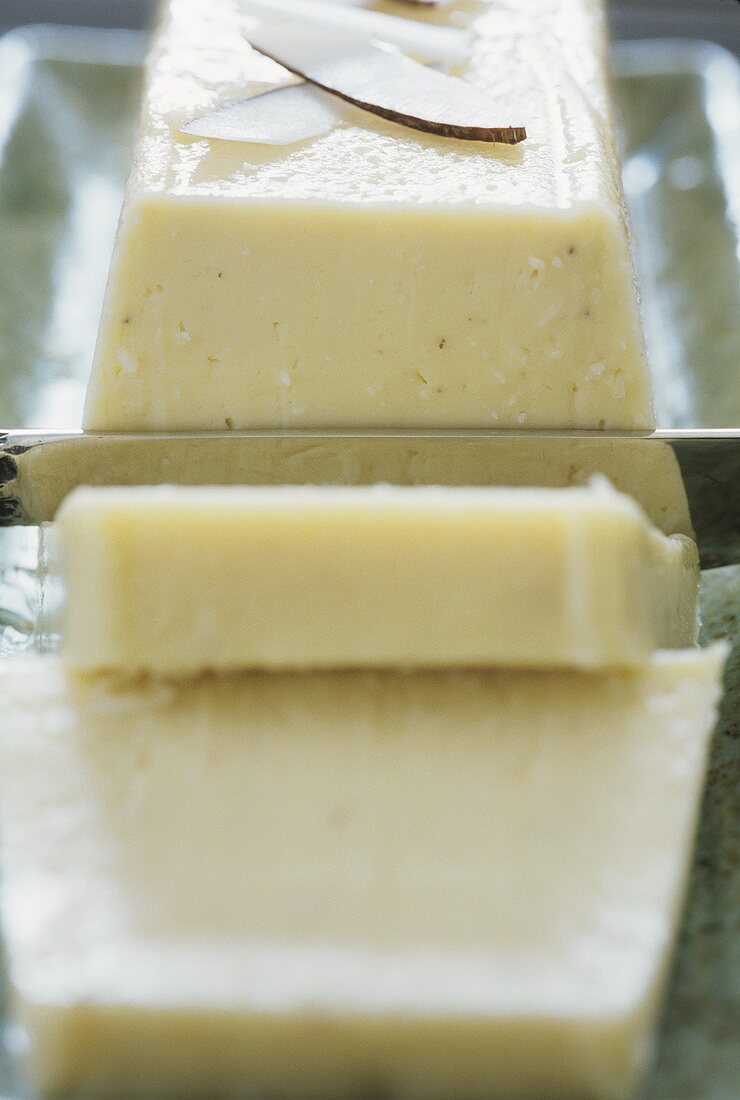 Coconut terrine with coconut curls (a piece cut)