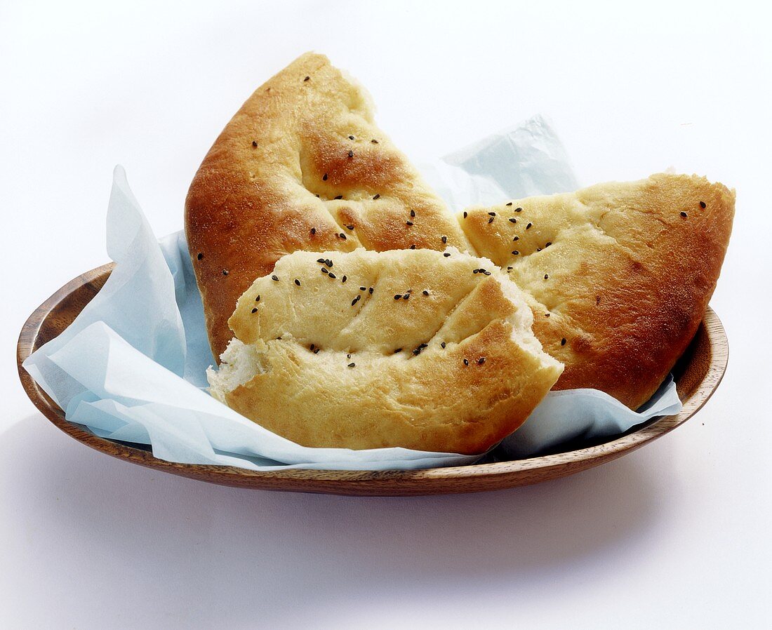 Turkish flatbread in pieces on plate