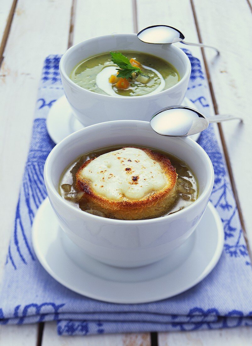Vegetable soup and onions soup with toasted cheese topping