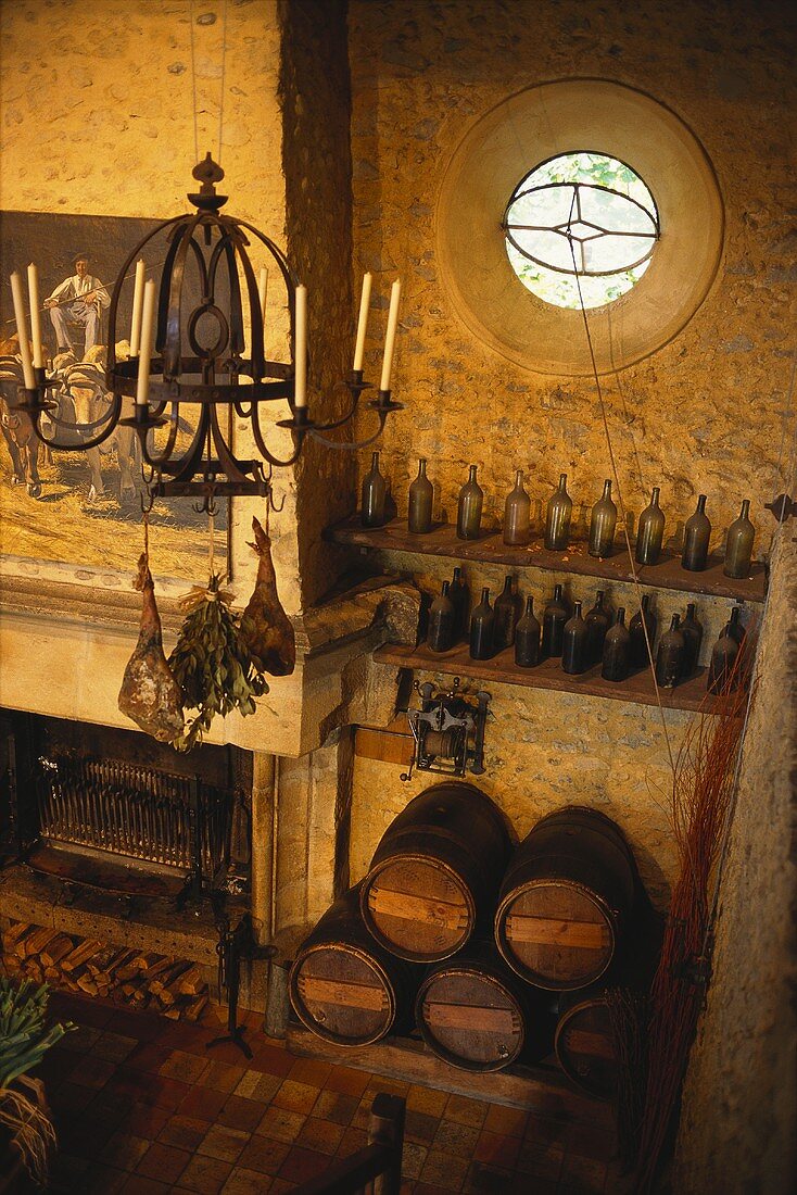 French restaurant with open fire, wine barrels and bottles