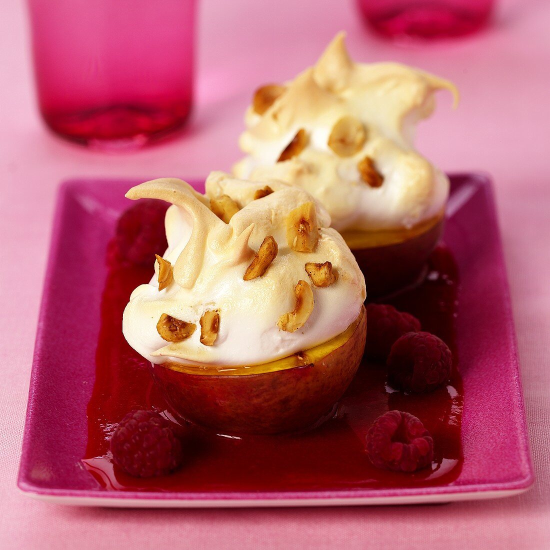 Peach brulee with raspberry sauce and nuts