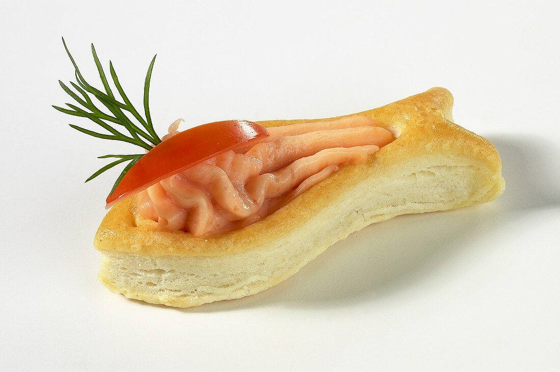 Salmon mousse with tomato wedge in puff pastry fish
