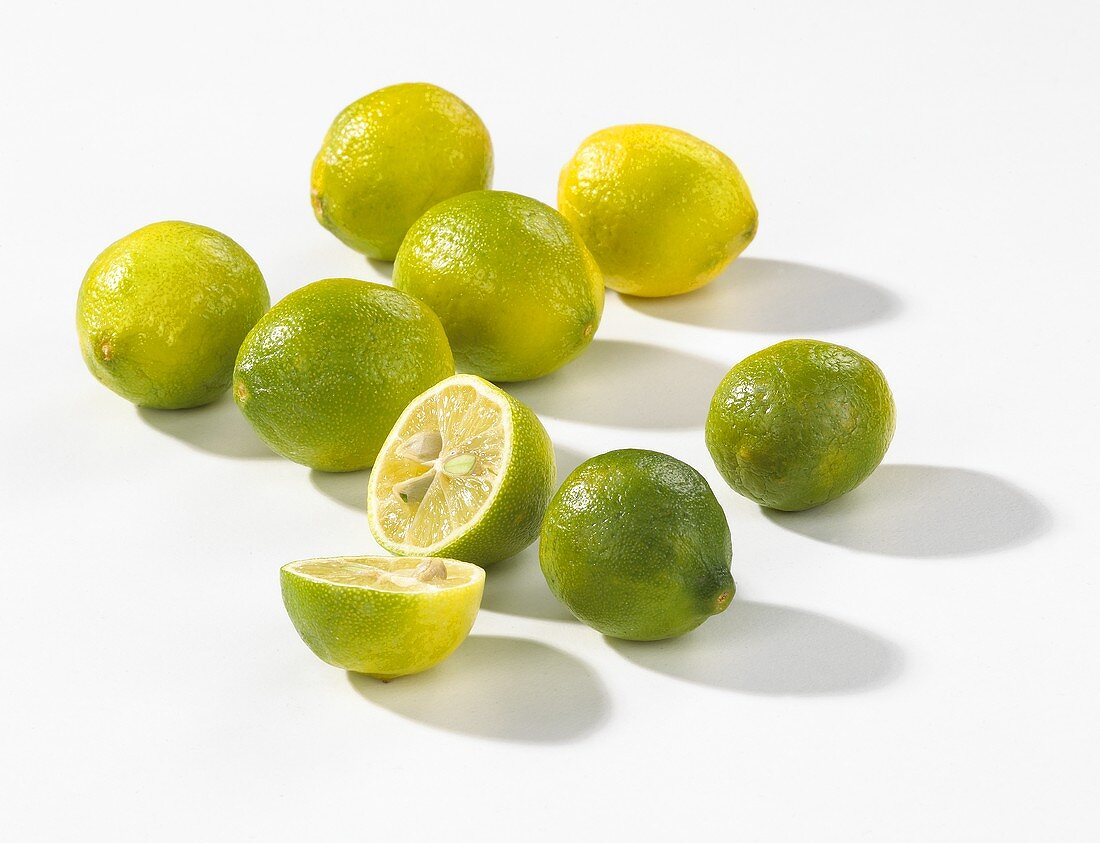 Several limes, one halved