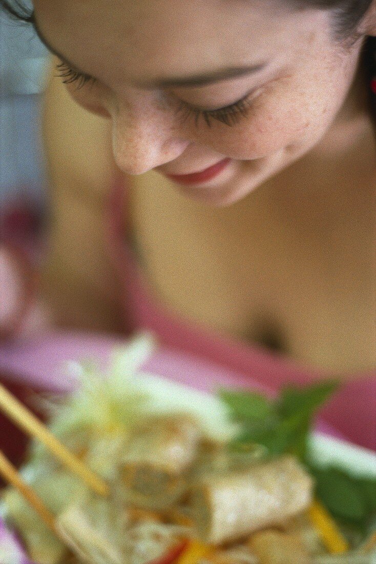 Woman eating spring rolls