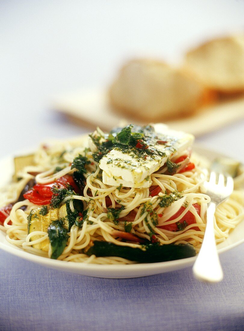 Spaghetti with vegetables, mint and goat's cheese