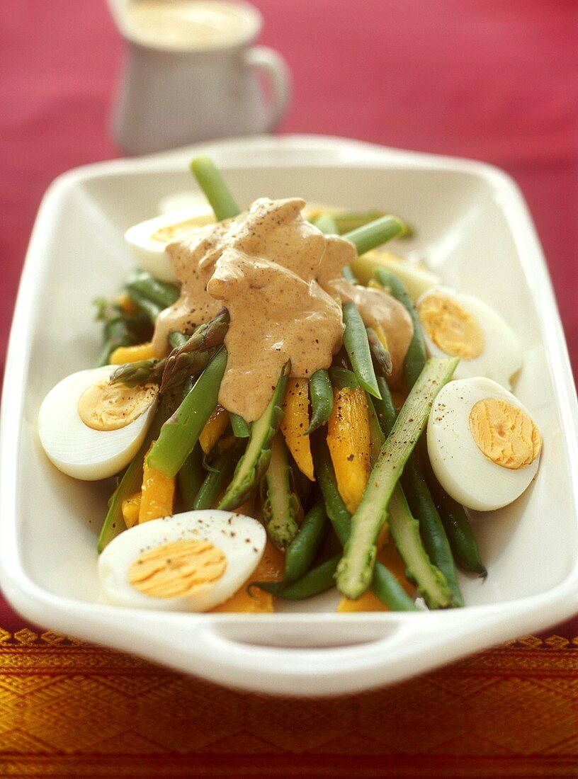 Asparagus and bean salad with mango, egg and curry dressing