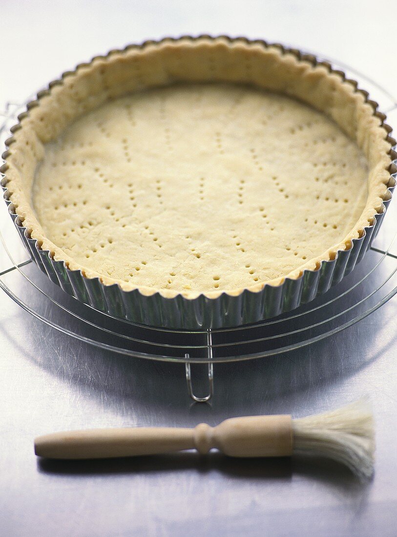 Pricking shortcrust pastry base with fork