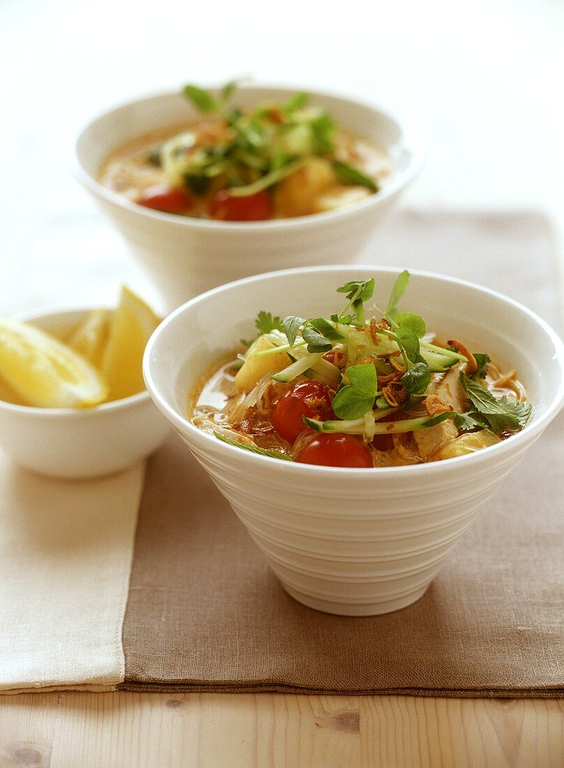 Chicken soup with cherry tomatoes and herbs