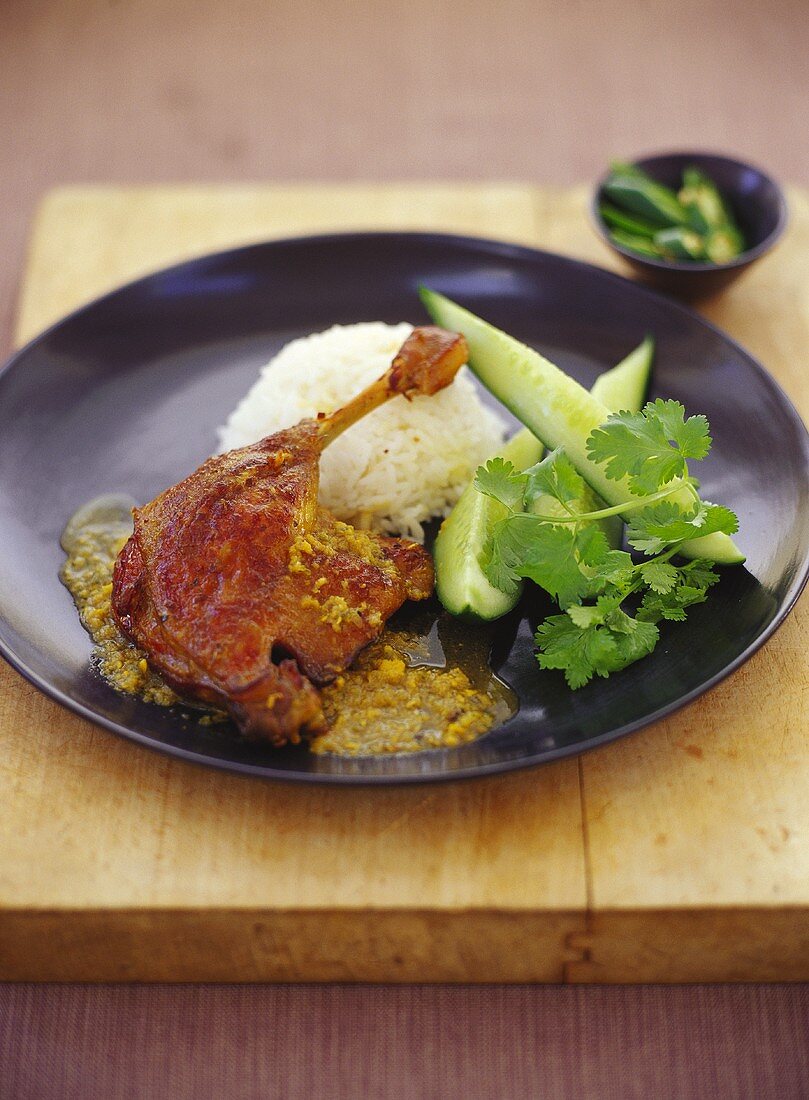 Duck leg with rice and wedges of lime