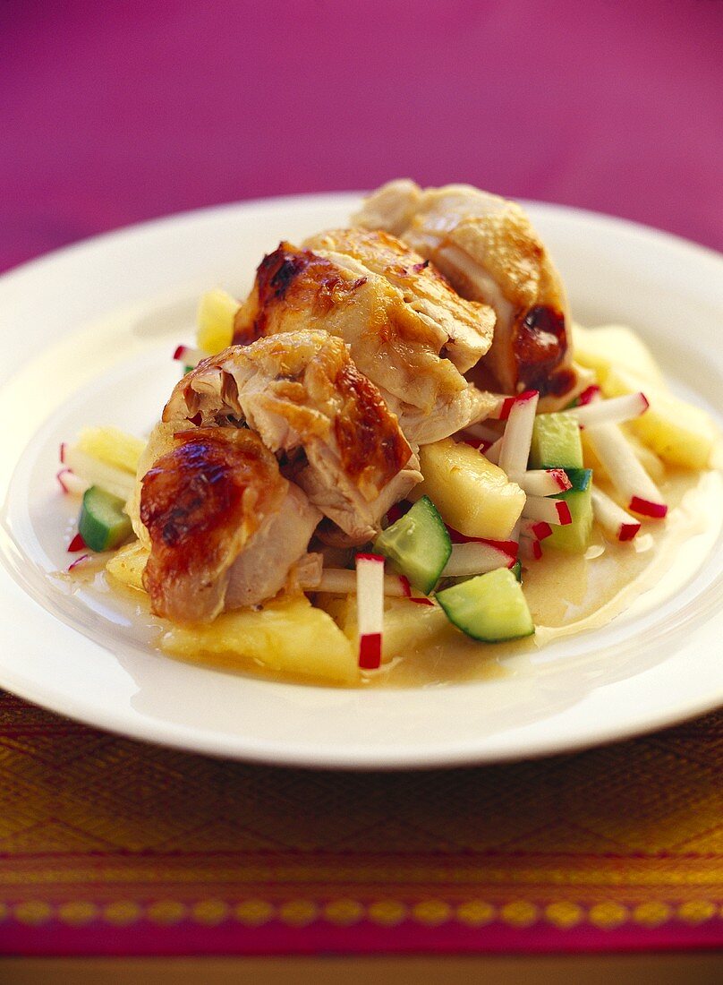 Chicken breast on cucumber and radish salad with pineapple
