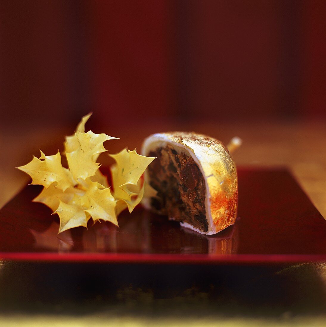Small mince pie with gold and silver leaf, a piece cut off