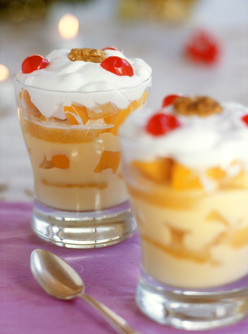 Trifle with peaches in glasses