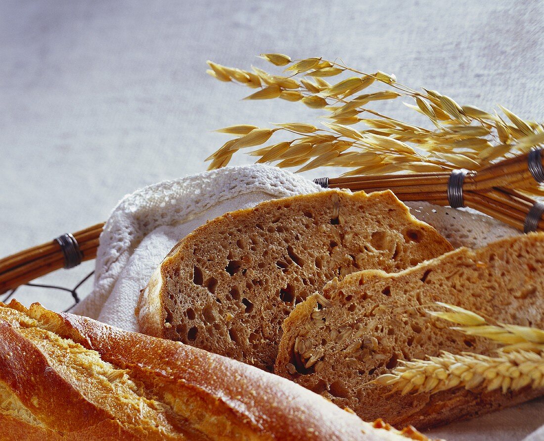 Baguette and wholemeal bread in bread basket