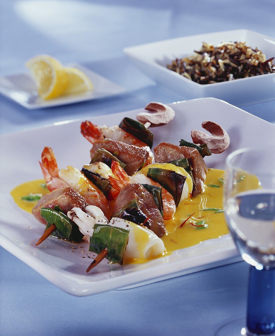 Seafood and ramsons (wild garlic) kebab on saffron sauce