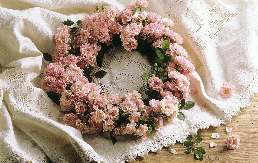 Wreath of pink roses on lace cover