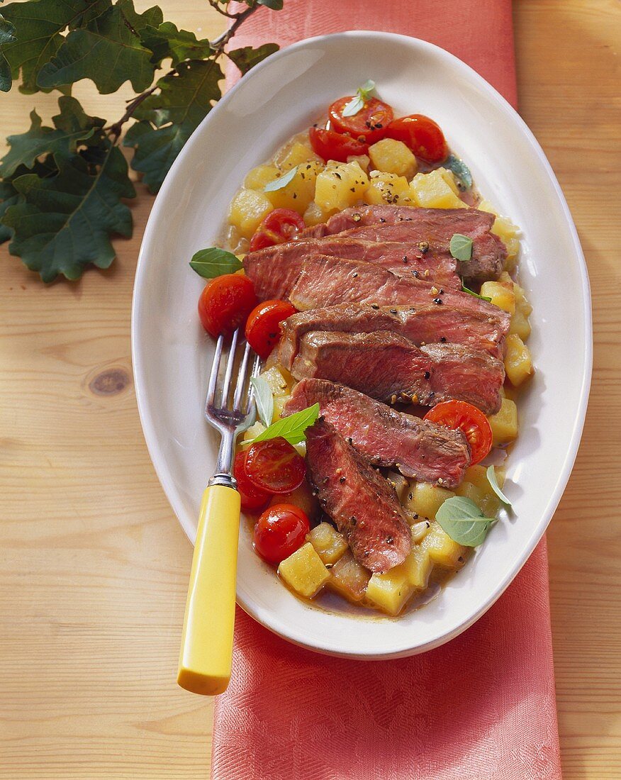 Beef steak with potatoes and cherry tomatoes