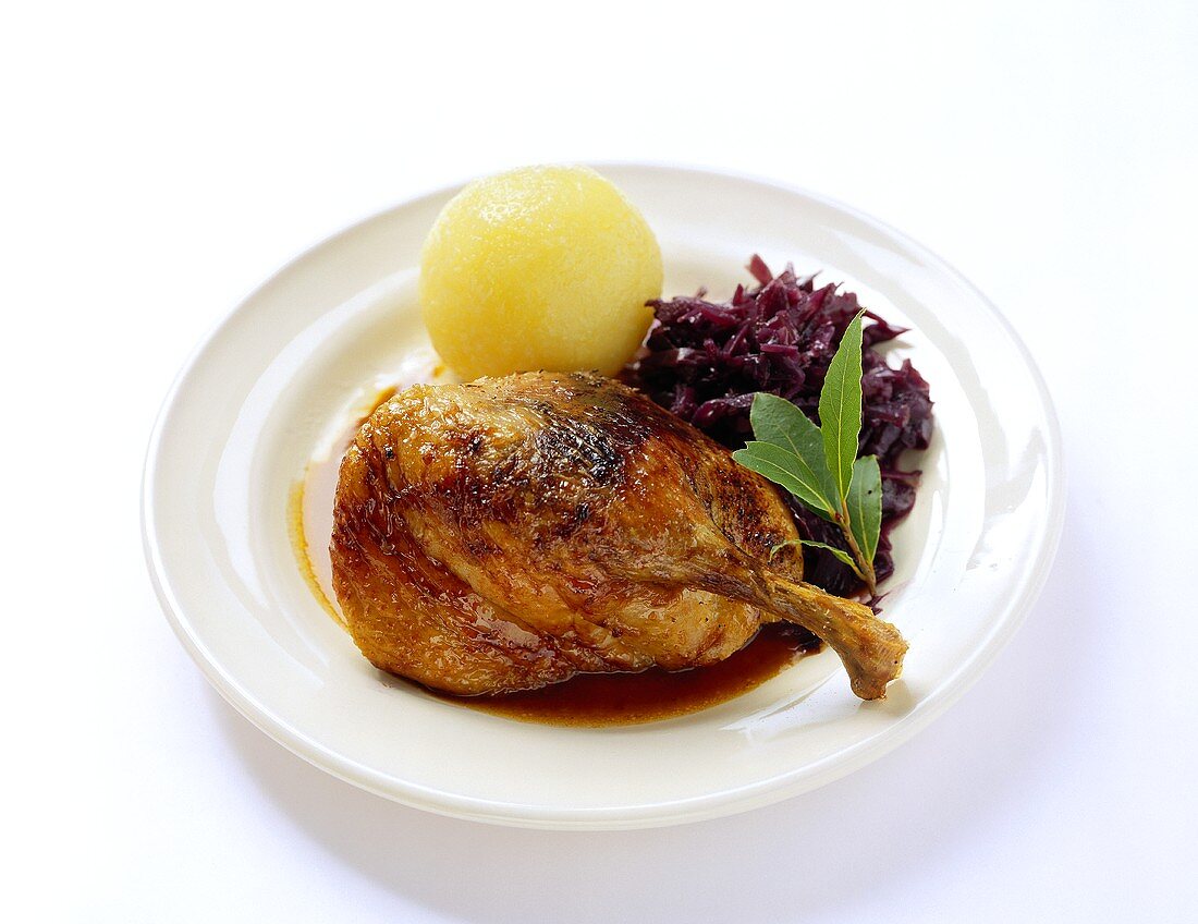 Duck leg with potato dumpling and red cabbage