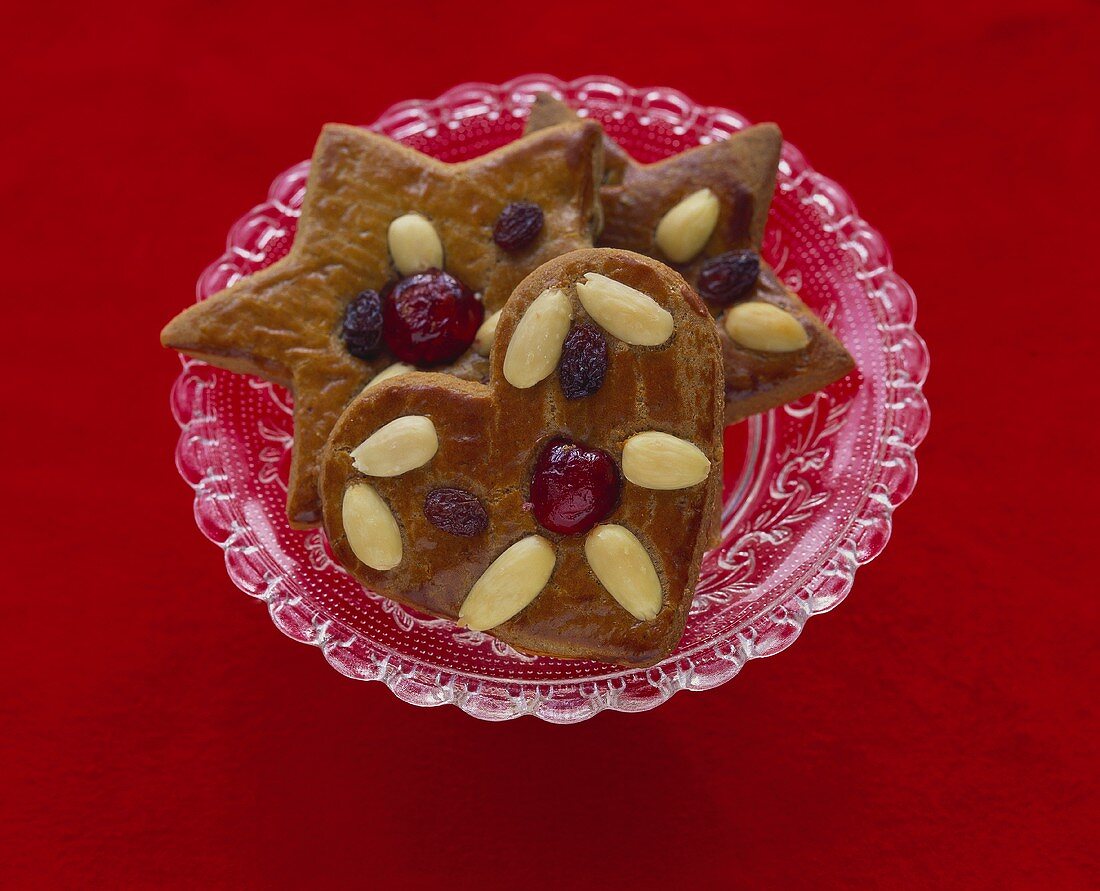 Gingerbread with almonds and candied cherries on plate