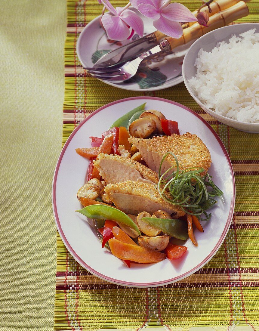 Turkey breast with sesame crust and Asian vegetables; rice