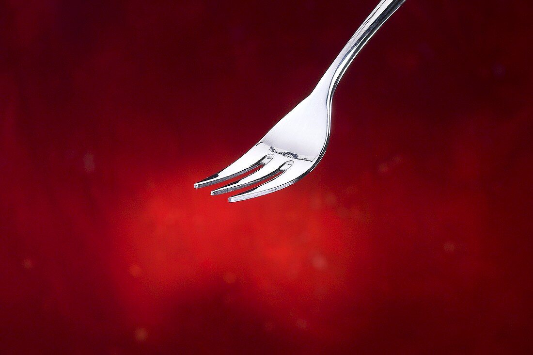 Fork against red background