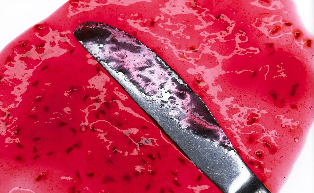 Berry jam with knife