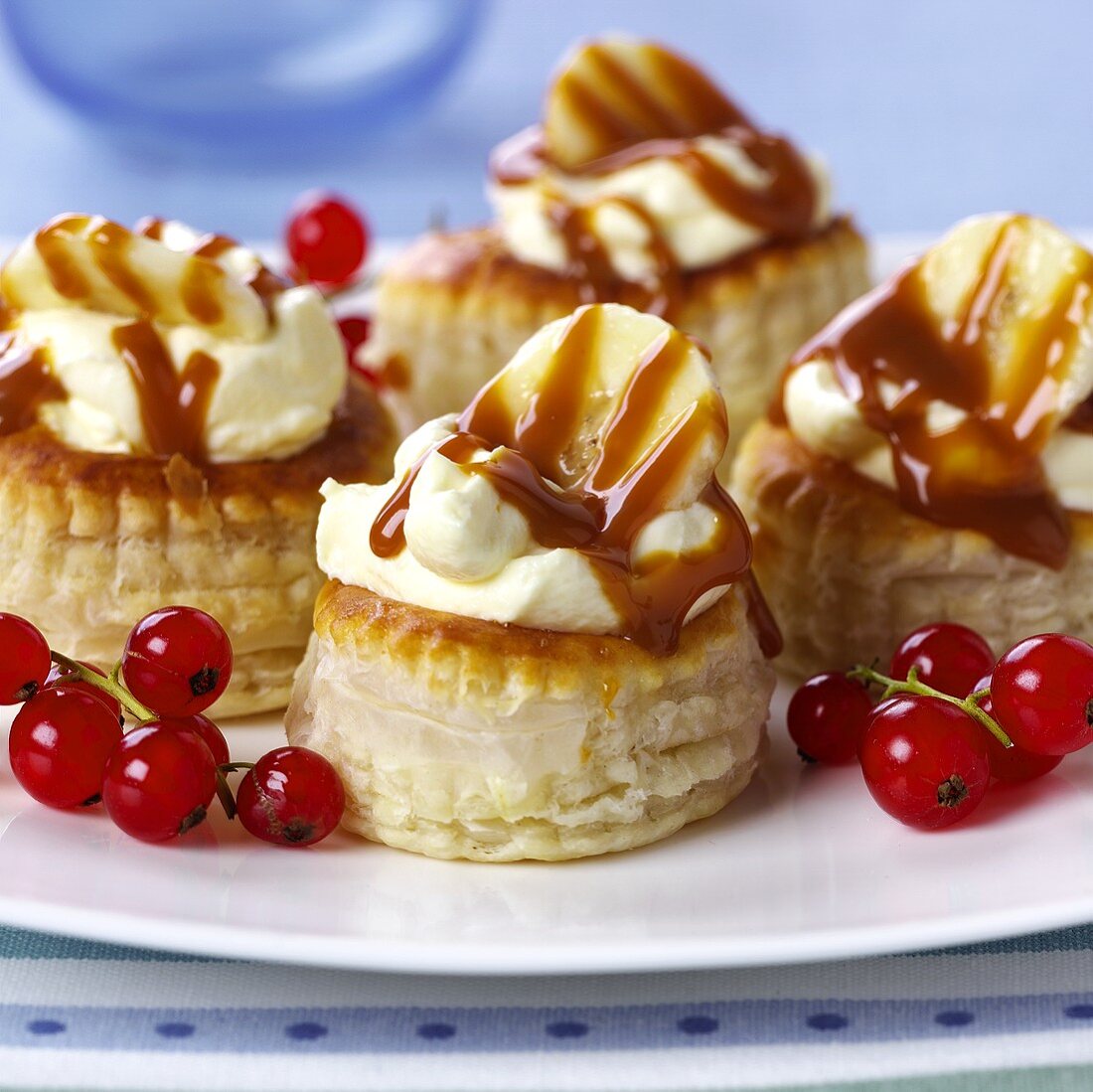 Sweet puff pastries with banana cream and caramel sauce